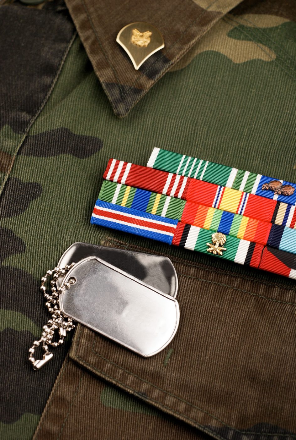 Military medals and dog tags on a uniform
