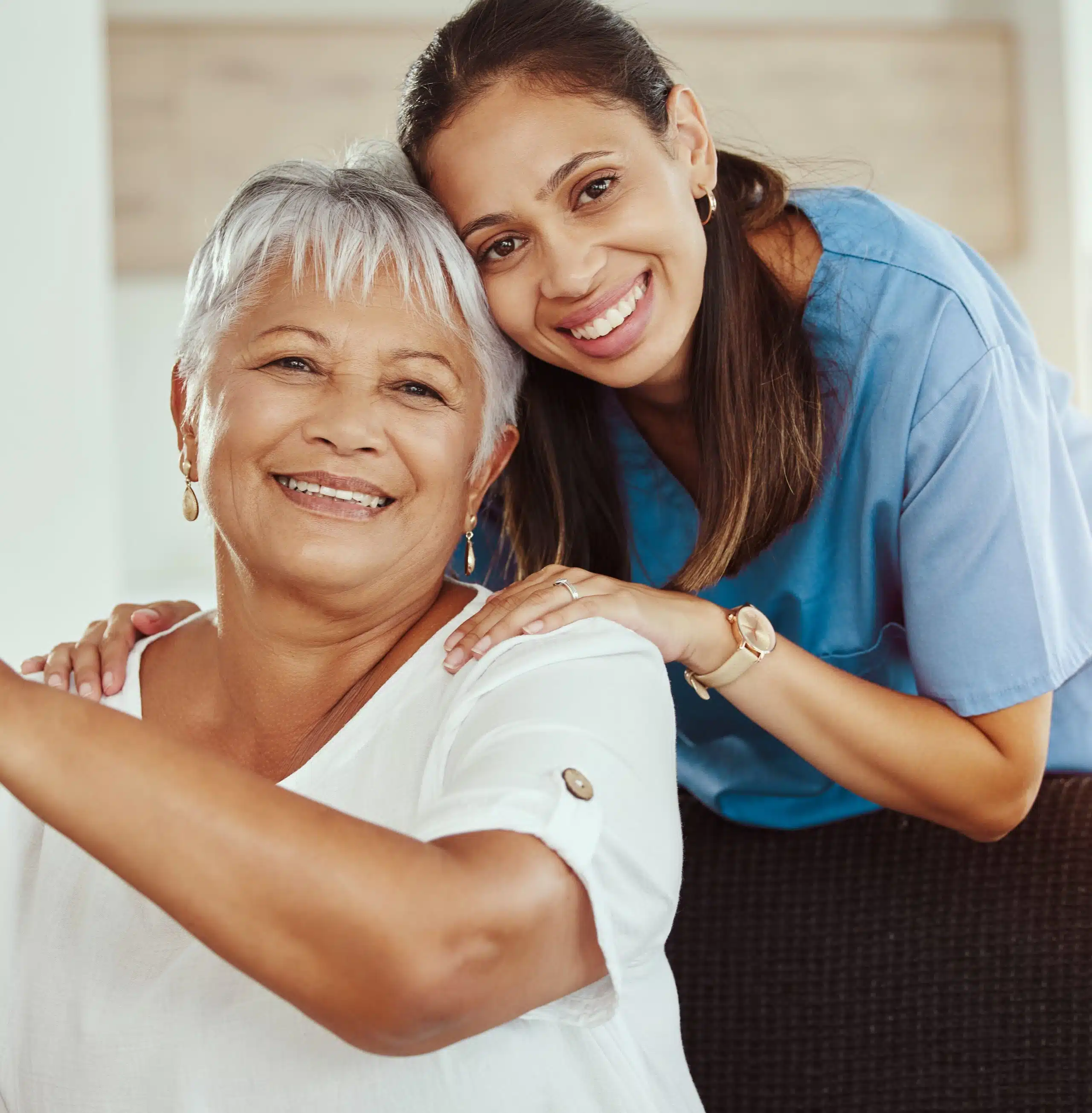 Home healthcare worker embracing her grandmother.