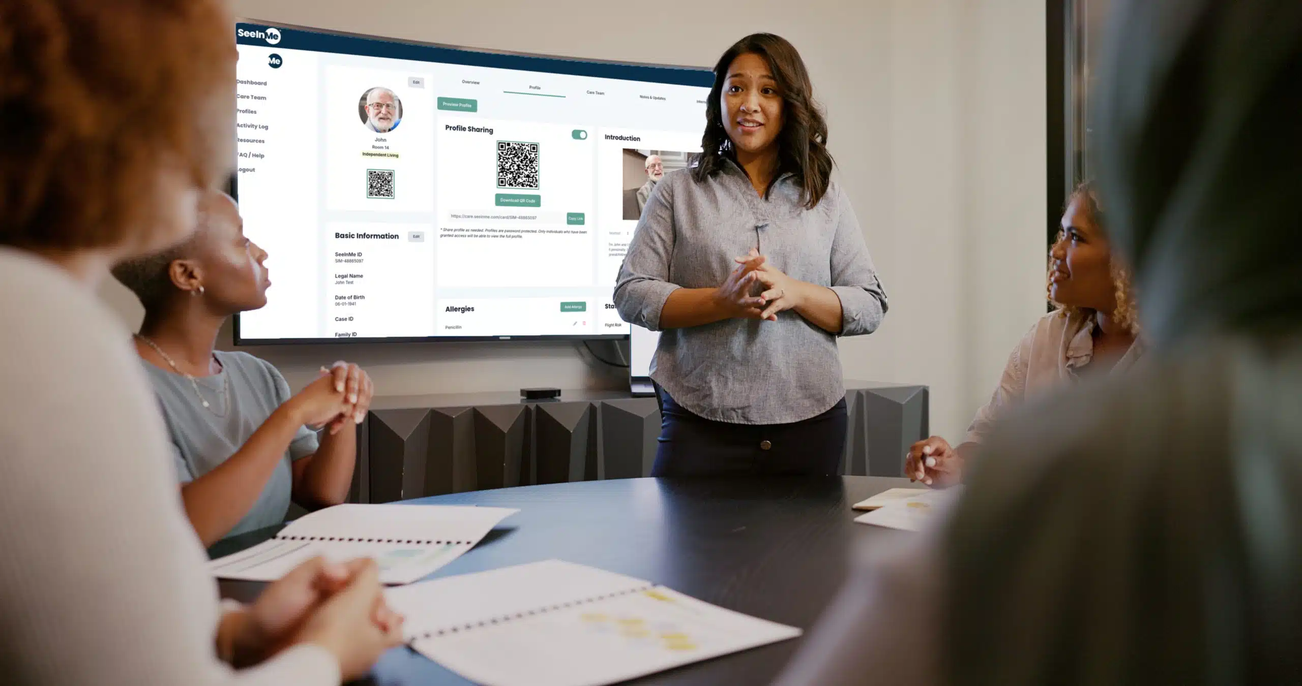Business woman walking her team through a new patient's profile